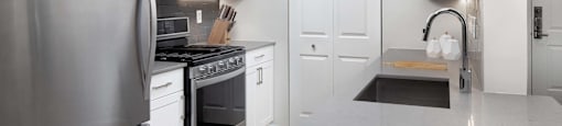 a kitchen with stainless steel appliances and white cabinets