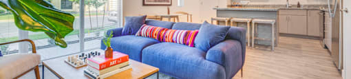 a living room with a blue couch and a coffee table