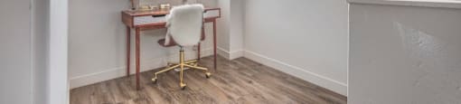 an office space with a desk and a window