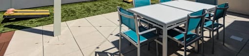 A patio with a table and chairs is set up on a rooftop.