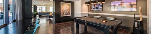 A room with a pool table and a television.