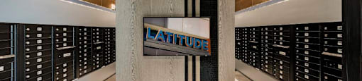 A sign that says Latitude is hanging on a wall.