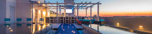 A modern building with a pool in front of it.