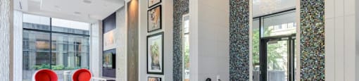 A bathroom with a white tiled floor and a mosaic tile wall.