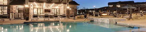 A modern house with a pool in front.