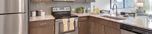A modern kitchen with wooden cabinets and stainless steel appliances.
