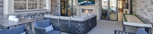 A patio with a fireplace and seating area.