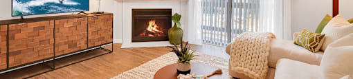 A living room with a fireplace and a television.