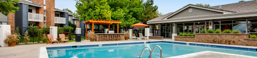 A swimming pool in a residential area with a building in the background.