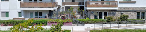 A modern apartment complex with white buildings and balconies.