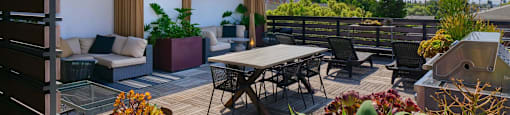 A modern house with a wooden deck and patio furniture.