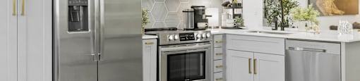 A modern kitchen with a stainless steel refrigerator and oven.