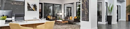 A modern office space with a desk, chairs, and a laptop.