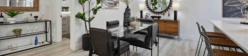 A modern dining room with a wooden table and chairs.