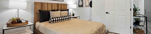 A bedroom with a bed, a ceiling fan, and a rug.