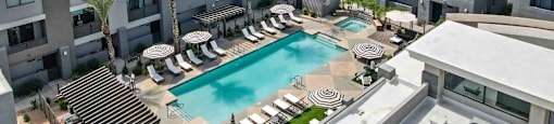 A large apartment complex with a pool in the middle.