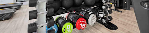 A gym with a variety of equipment including weights and a treadmill.