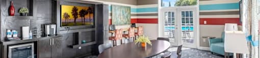 A modern dining room with a round table and chairs.