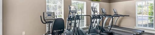 A spacious home gym with a variety of exercise equipment.