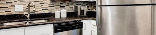 A modern kitchen with a stainless steel refrigerator.