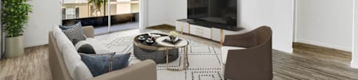 A living room with a couch, chair, and television.