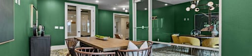 A dining room with a wooden table and chairs.