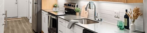 A modern kitchen with wooden cabinets and stainless steel appliances.
