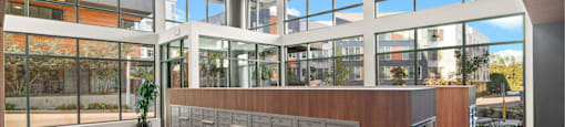 A reception area with a wooden desk and a large window.