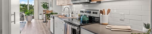 A modern kitchen with wooden cabinets and stainless steel appliances.