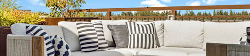 A modern outdoor seating area with a fire pit.