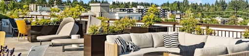 A patio with wooden furniture and a view of buildings in the distance.