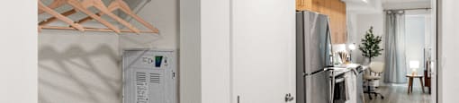 A modern kitchen with a refrigerator and a white wall.