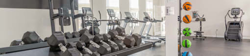 A gym with a variety of equipment including dumbbells and weight machines.