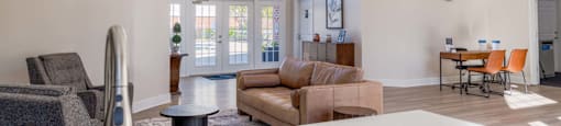 clubhouse with a couch, chairs, and a dining table.