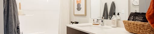 A bathroom with a toilet, sink, and shower.