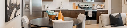 A modern kitchen with a dining table set for four.
