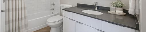 Upgraded full bathroom with modern lighting and tile shower surround