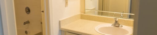 Model unit bathroom with vanity, tub/shower, and toilet