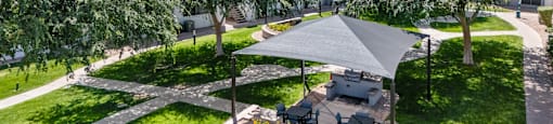 A backyard with a patio and a gazebo.