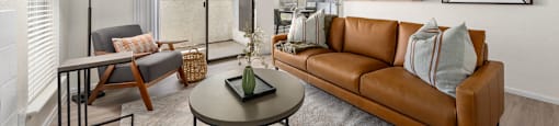A living room with a brown couch and a coffee table.