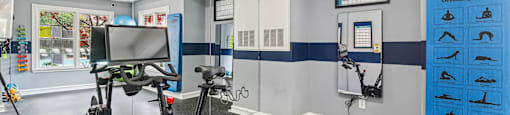 A room with a wall-mounted sign that says "SmartMatic" and a row of exercise bikes.