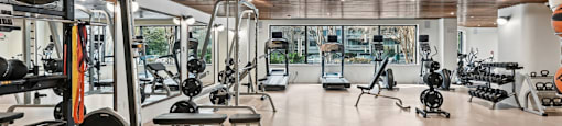 Brand new Fitness Center with a variety of equipment including treadmills, weights, and exercise machines.