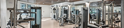 Renovated Fitness Center with a variety of equipment including a leg press machine.