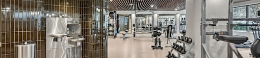 Brand new gym with a variety of equipment and a wooden ceiling.