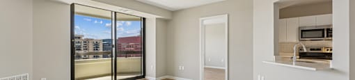 Inviting living room with a sliding glass door leading to a balcony.