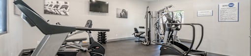 A gym with treadmills and exercise bikes.
