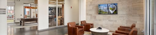 a lobby with couches and chairs and a table