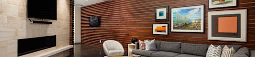 a living room with couches and chairs and a television