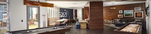 a large living room with a pool table and other furniture