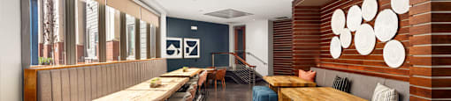 a dining room with wooden tables and chairs and benches